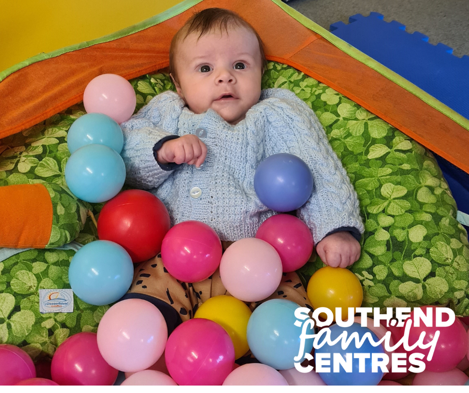 baby in a play ball pit