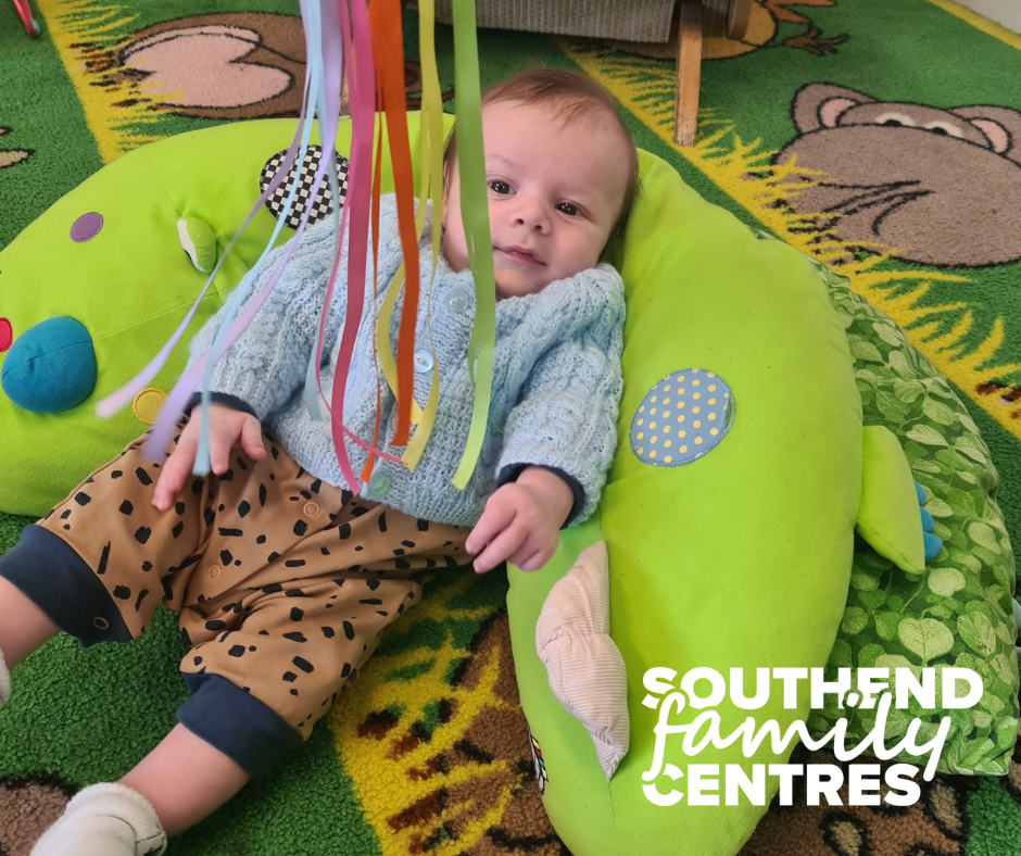Baby watching sensory ribbons.